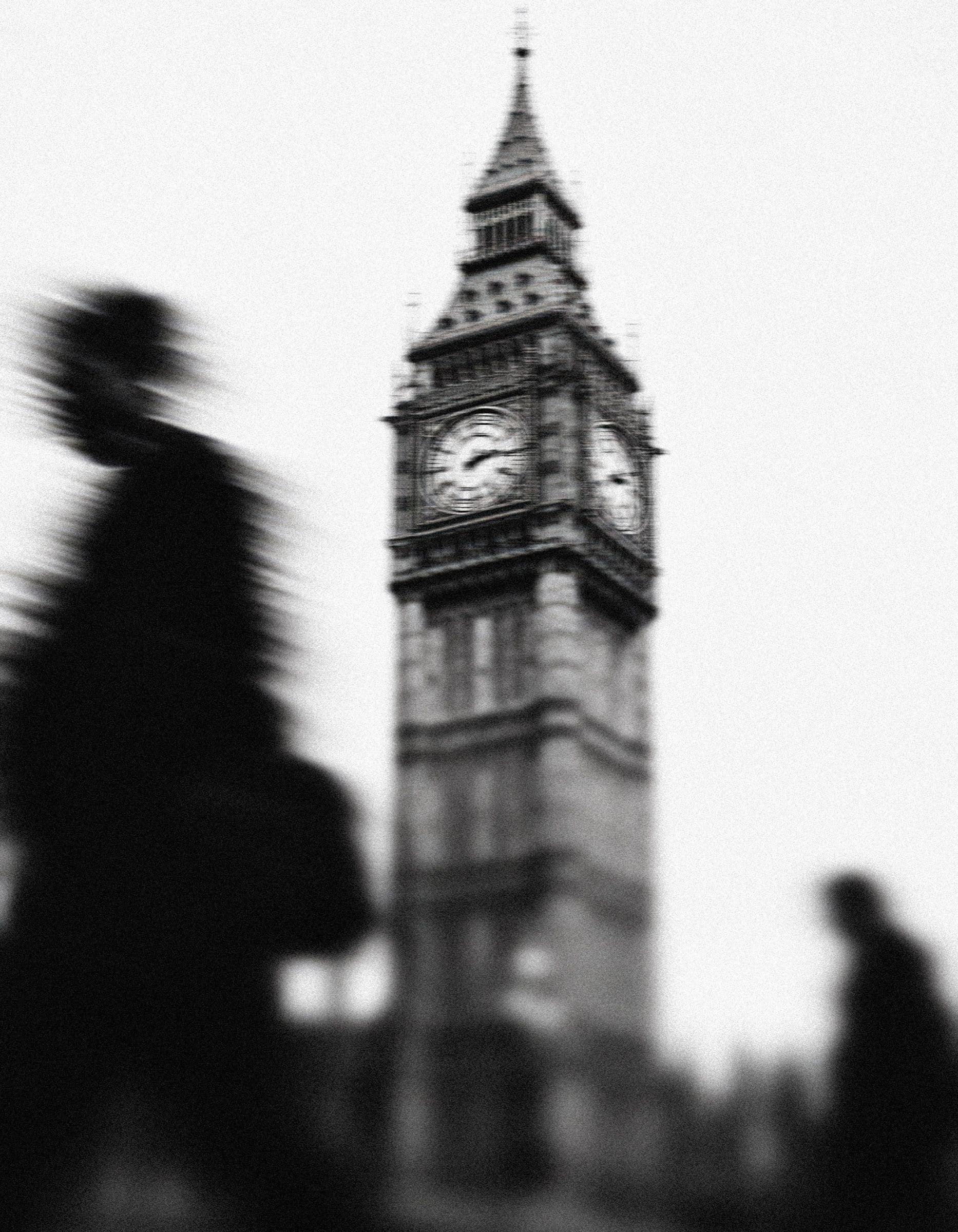 Big Ben seen from the street, with passers-by blurred in motion