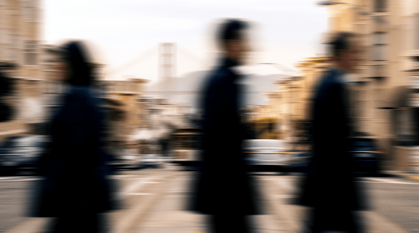 Commuters on a San Francisco hill street with the Golden Gate Bridge behind
