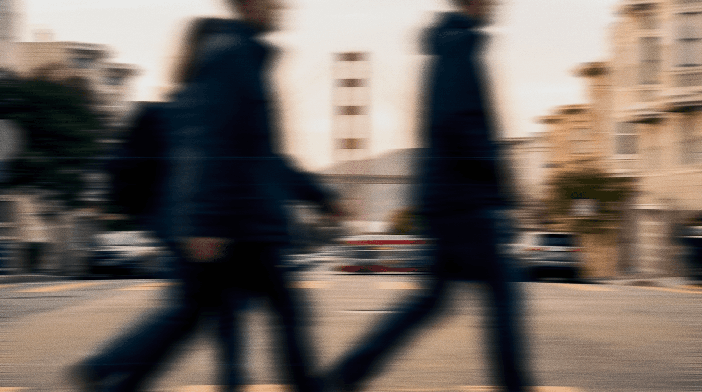 People crossing a San Francisco street with the Golden Gate Bridge behind