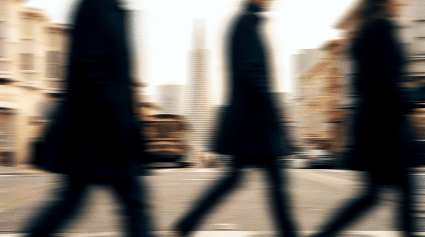 Commuters crossing a San Francisco street near the Transamerica Pyramid