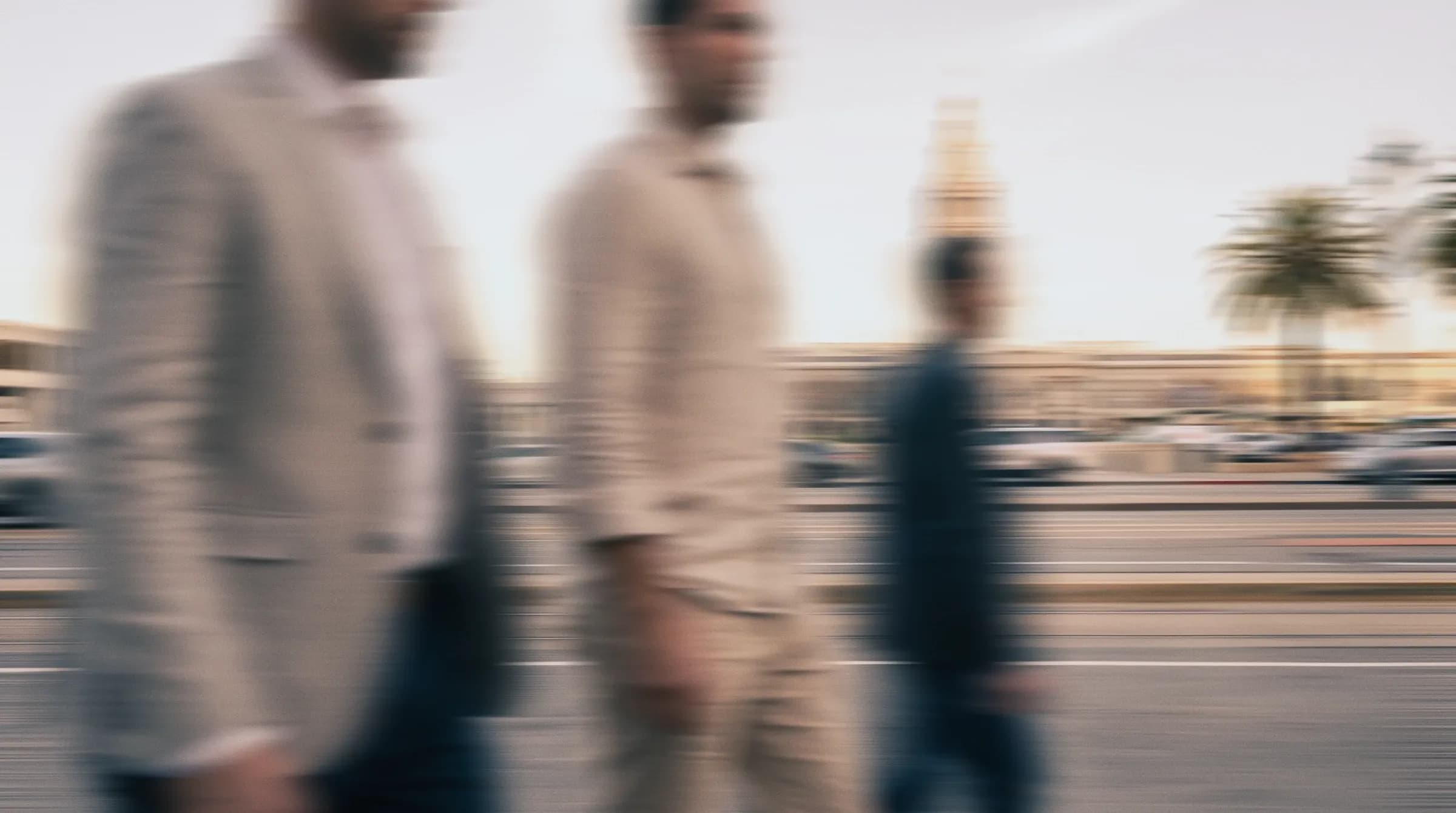 People walking past palm trees in Miami, blurred in motion